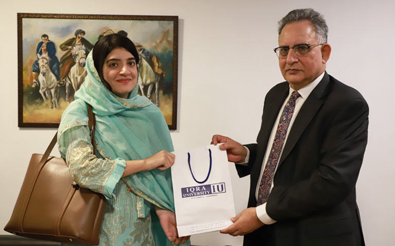Ms. Aimen Naeem, Research Associate at Capacity Analytics meeting with Dr. Eatzaz Ahmad, Dean of Social Sciences at Iqra University.
